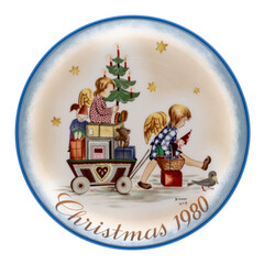 Vintage Sister Berta Hummel Christmas Plate from 1980 entitled Parade Into Toyland, isolated on white.