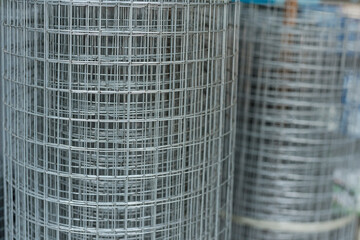 A roll of galvanized steel matting or welded wire mesh for sale at a hardware store.