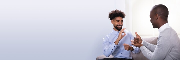 Two Happy Men Making Sign Language © Andrey Popov