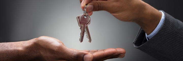 Hand Passing Keys To New Owner