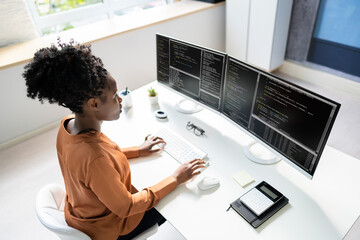 Computer Programmer Writing Program Code On Computer