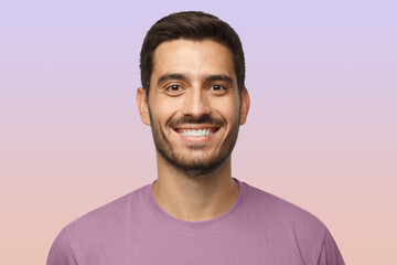 Close up portrait of smiling handsome man in t-shirt isolated on purple background