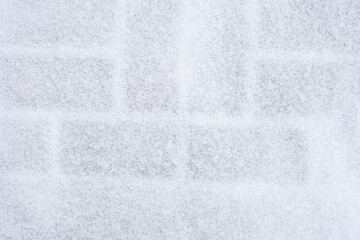 brick wall, marked by snow, background brick in the snow