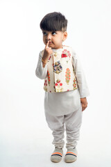 Cute indian little child in ethnic wear and showing expression over white background