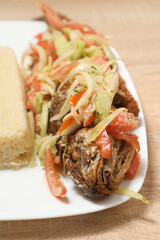 Delicious African dish featuring grilled fish with vegetables and a side of couscous served at a local restaurant