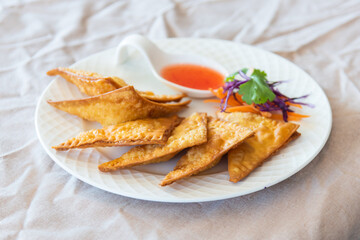 Thai food appetizer of fried wontons on plate