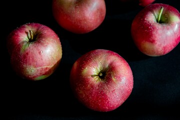 Red apples on dark surface top view