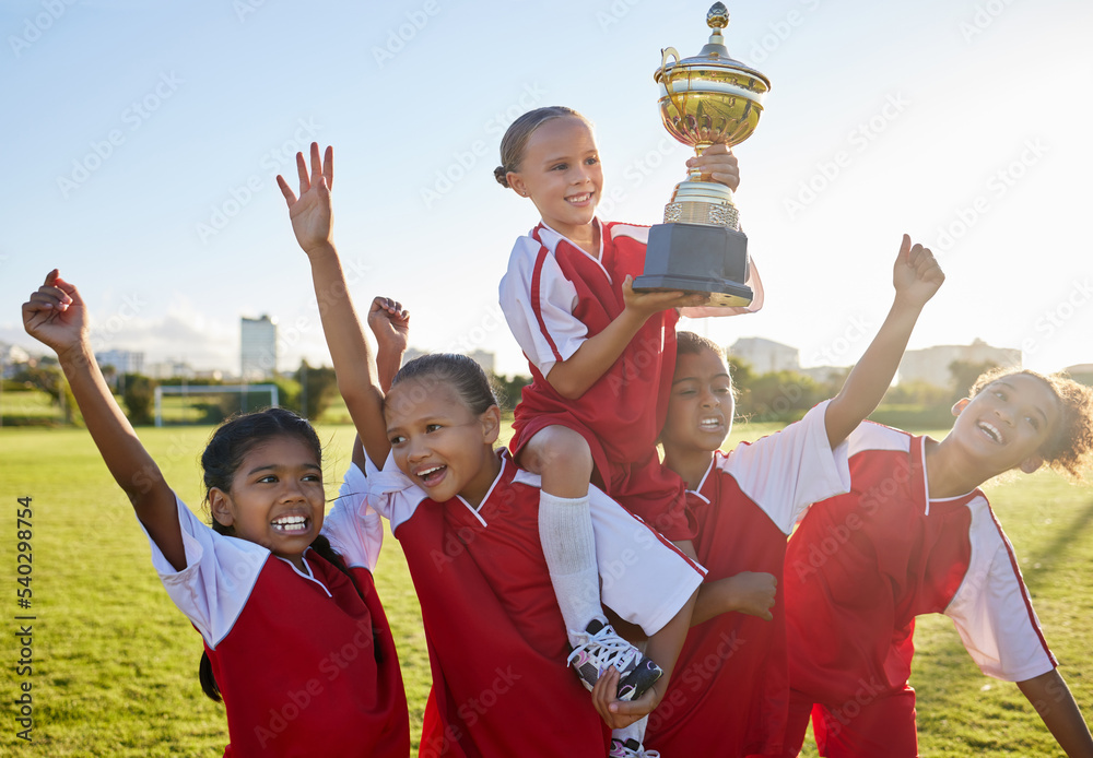 Poster Trophy, winner and football children with success, winning and excited celebration for sports competition or game on field. Happy soccer girl kids team with motivation, celebrate winning achievement