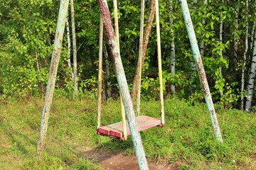 Fototapeta premium Old metal rusty swing in the park