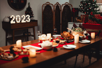 Chirstmas dinner including turkey place on family table ready to be eaten.