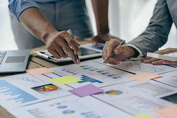 Financial manager meeting to discuss the success of the company's growth project. financial statistics Getting Started for Strategic Plans with Financial Documents and laptop in the office