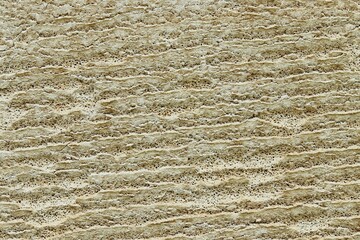 Background, texture of low-quality foam concrete after active exposure to water and wind