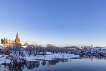 Fototapeta premium Walking along the Nidelven (river) on a cold winter's day in Trondheim city, Trøndelag, Norway