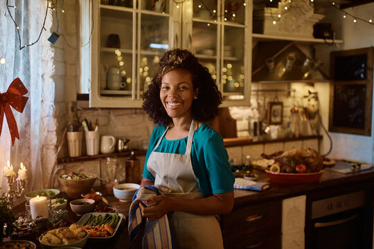 Happy Black Woman Making Thanksgiving Dinner In Kitchen And Looking At Camera.