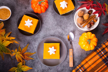 Slice of fresh baked traditional american homemade pumpkin pie decorating whipped cream for celebrating holidays