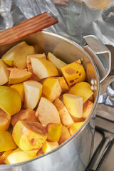 Preparation of the quince meat recipe, chopped quince and apple fruit in a pot to cook for hours until get the delicious sweet.