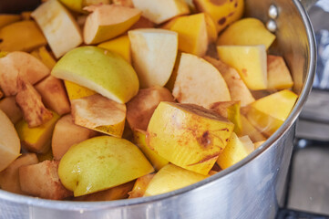 Preparation of the quince meat recipe, chopped quince and apple fruit in a pot to cook for hours until get the delicious sweet.