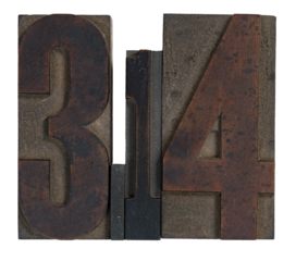 Isolated antique wood block type in reverse spelling 3.14 for pi day