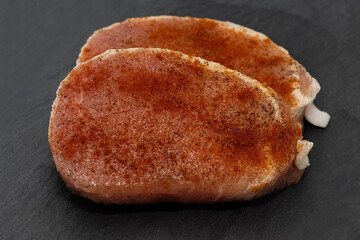 Fresh tender pork steaks with spices and red paprika. Ingredients for cooking at home. Close-up