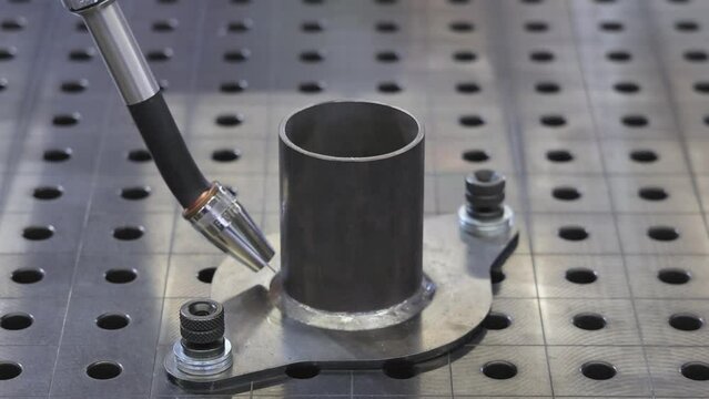 Metal Pipe Automated Welding Process Robot Arm at Work Table