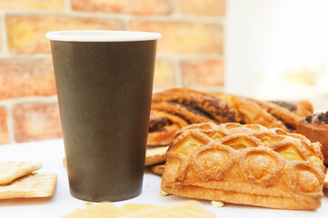 Paper cup empty mockup with pastries in city cafe