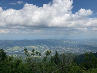 Summer day blue sky mountains landscape. Nature landscape with sun and blue sky. Summer travel in Europe mountains. Nature, lake, forest, trees hiking path. Clouds on blue sky. Forest landscape hiking