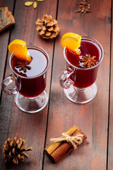 Christmas mulled wine with anise and orange slice. Mulled wine, cinnamon sticks and cloves on wooden boards. Traditional hot drink at Christmas time