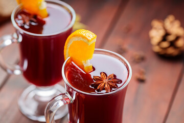 Christmas mulled wine with anise and orange slice. Mulled wine, cinnamon sticks and cloves on wooden boards. Traditional hot drink at Christmas time