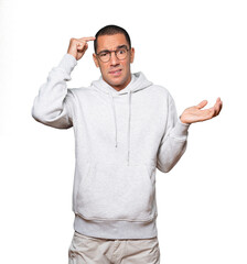 Concerned young man doing a gesture of confusion