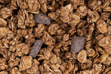 Overhead close view of a serving of chocolate chunk granola.