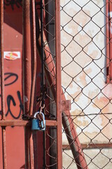 old rusty lock on hanging on the fence