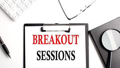 BREAKOUT SESSIONS text written on paper clipboard with office tools