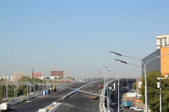 New traffic intersection road construction site on blue sky background. Development of transport infrastructure junction, improvement highway. Overpopulation problem. Erection overpass in the big city