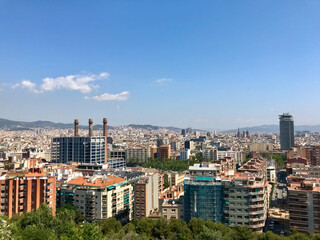 Barcelona, Spain, June 2019 - A view of a city with tall buildings in the background