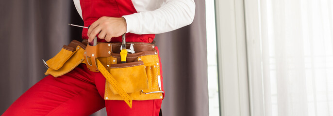 man and tools in leathern belt