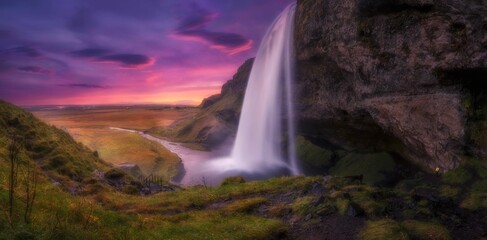 Dreamy view of the Seljalandsfoss in Iceland during a pinky sunset