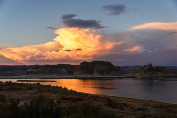 Blue Hour on Lake Powell viewed from Arizona looking at the Utah Shore. The glistening clouds shimmer on the lake.