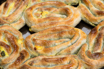 Eid Mubarak Traditional Ramadan Iftar dinner. Assorted tasty food in authentic rustic dishes on wooden blue background. Turkish Bosnian food meat kebab, pita, Sarma, klepe, sogan dolma.