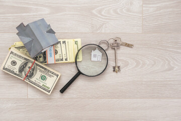 dollar, toy house next to a magnifying glass, sale of real estate, rental housing