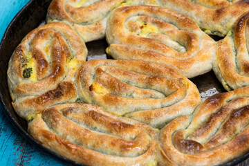 Eid Mubarak Traditional Ramadan Iftar dinner. Assorted tasty food in authentic rustic dishes on wooden blue background. Turkish Bosnian food meat kebab, pita, Sarma, klepe, sogan dolma.