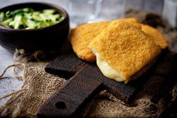 Cordon blue with cheese and cucumber salad