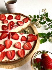 Strawberry cheescake. Delicious strawberry tart on a white wooden background, top view	