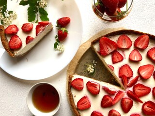 Strawberry cheescake. Delicious strawberry tart on a white wooden background, top view	