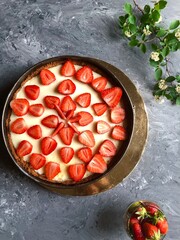 Strawberry cheescake. Delicious strawberry tart on a gray wooden background, top view	