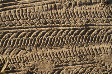 Abstract background. trail of motorcycle tires in the sand.