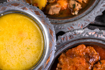 Eid Mubarak Traditional Ramadan Iftar dinner. Assorted tasty food in authentic rustic dishes on wooden blue background. Turkish Bosnian food meat kebab, pita, Sarma, klepe, sogan dolma.