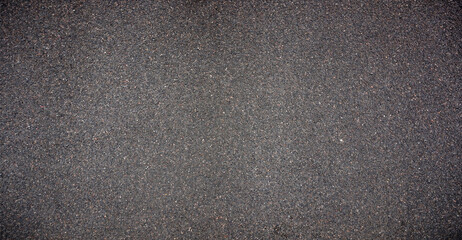 Black asphalt road texture background. Gray-grained road