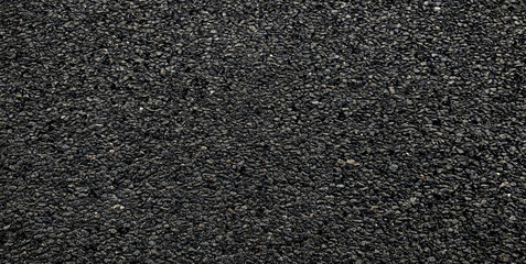 Black asphalt road texture background. Gray-grained road