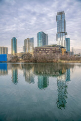 Fototapeta na wymiar Colorado River waterfront with a reflection of the cityscape at Austin, Texas