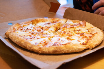 Cheese pizza in a cardboard box closeup